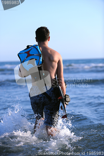 Image of Portrait of a young  kitsurf  man at beach on sunset