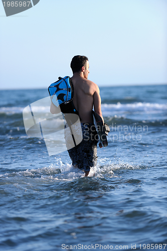 Image of Portrait of a young  kitsurf  man at beach on sunset