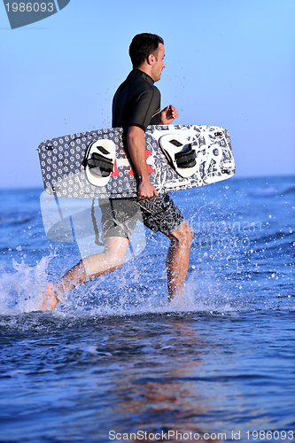 Image of Portrait of a young  kitsurf  man at beach on sunset