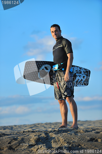 Image of Portrait of a young  kitsurf  man at beach on sunset