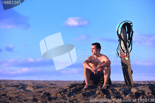 Image of Portrait of a young  kitsurf  man at beach on sunset