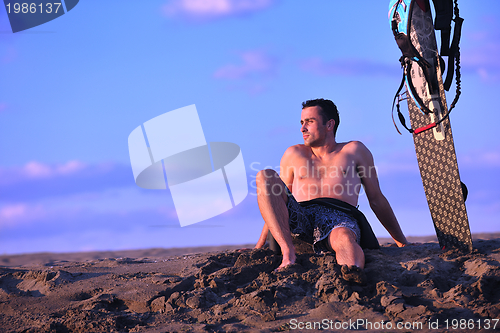 Image of Portrait of a young  kitsurf  man at beach on sunset