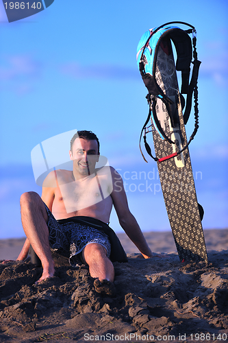 Image of Portrait of a young  kitsurf  man at beach on sunset