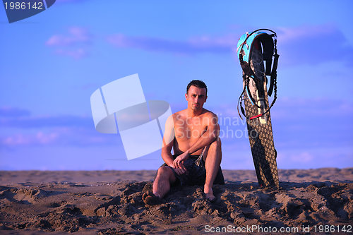 Image of Portrait of a young  kitsurf  man at beach on sunset