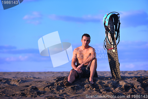 Image of Portrait of a young  kitsurf  man at beach on sunset