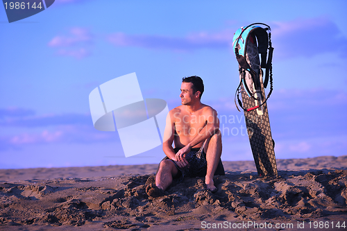 Image of Portrait of a young  kitsurf  man at beach on sunset