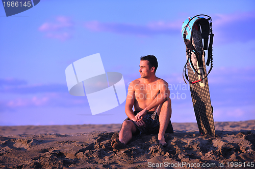Image of Portrait of a young  kitsurf  man at beach on sunset
