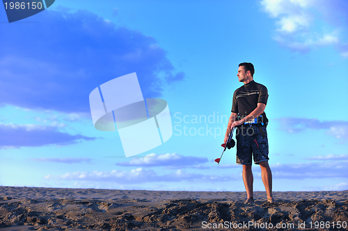 Image of Portrait of a young  kitsurf  man at beach on sunset