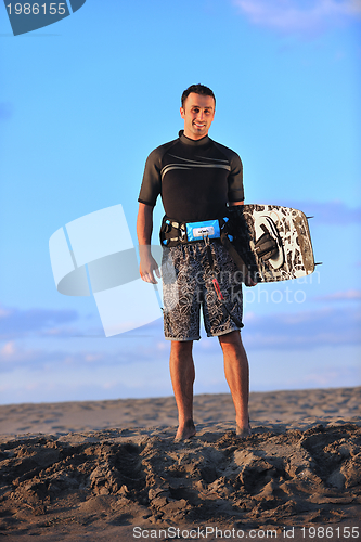 Image of Portrait of a young  kitsurf  man at beach on sunset