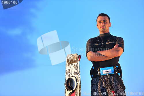 Image of Portrait of a young  kitsurf  man at beach on sunset