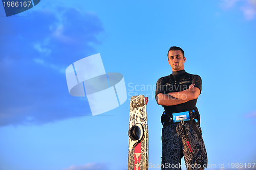 Image of Portrait of a young  kitsurf  man at beach on sunset