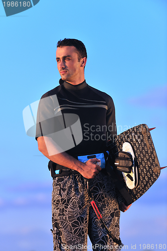 Image of Portrait of a young  kitsurf  man at beach on sunset