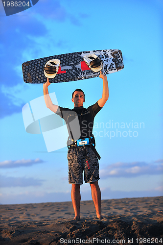 Image of Portrait of a young  kitsurf  man at beach on sunset