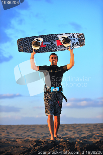 Image of Portrait of a young  kitsurf  man at beach on sunset