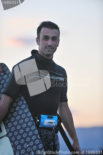 Image of Portrait of a young  kitsurf  man at beach on sunset