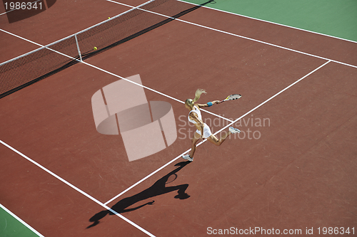 Image of young woman play tennis outdoor