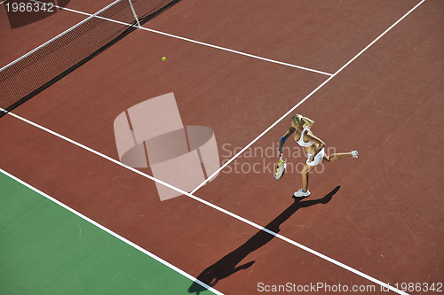 Image of young woman play tennis outdoor