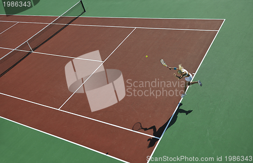 Image of young woman play tennis outdoor