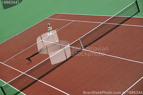 Image of young woman play tennis outdoor