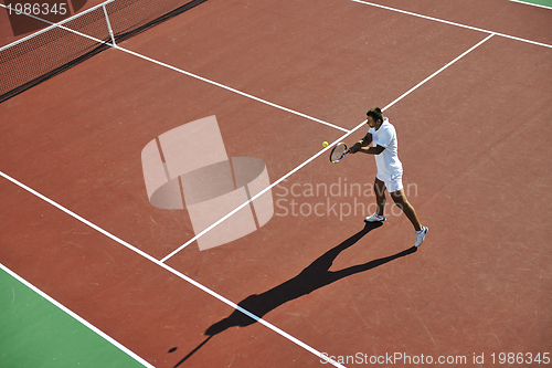 Image of young man play tennis outdoor