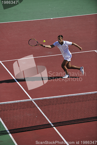 Image of young man play tennis outdoor