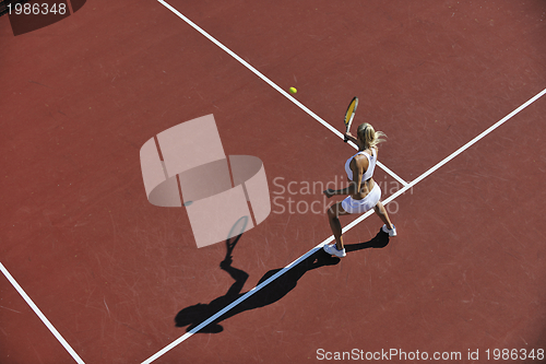 Image of young woman play tennis outdoor