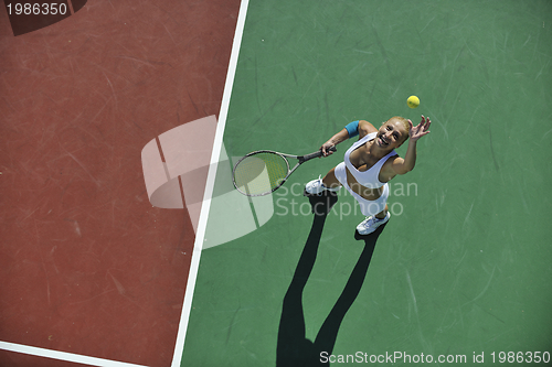 Image of young woman play tennis outdoor