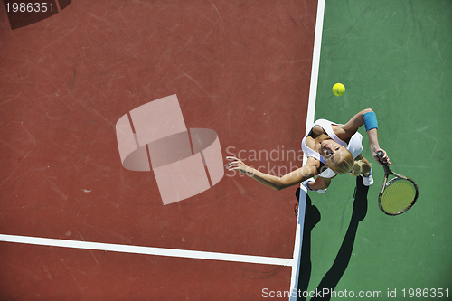 Image of young woman play tennis outdoor