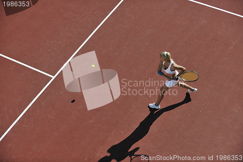 Image of young woman play tennis outdoor