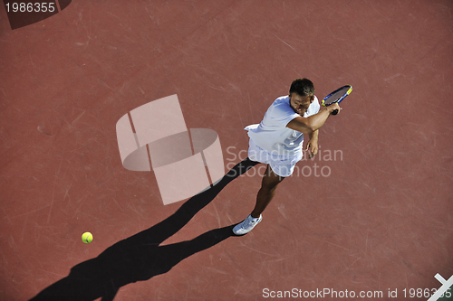 Image of young man play tennis outdoor