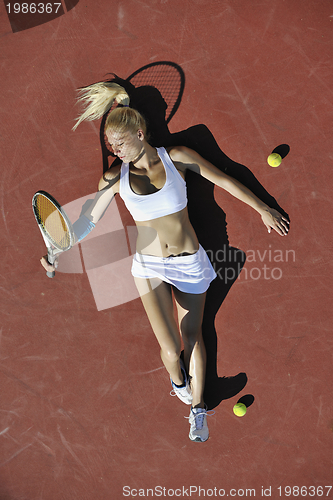 Image of young woman play tennis outdoor