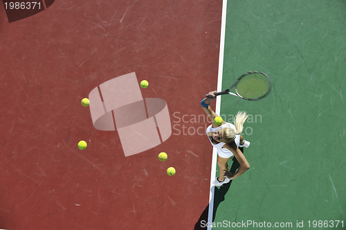 Image of young woman play tennis outdoor