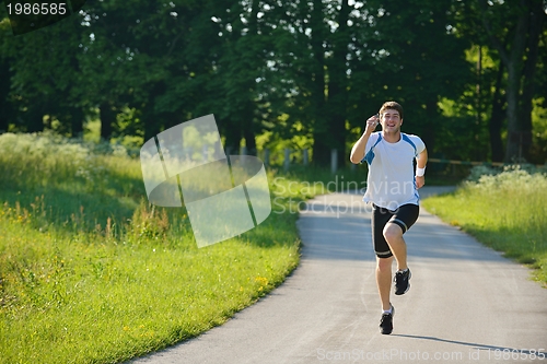 Image of Young couple jogging at morning