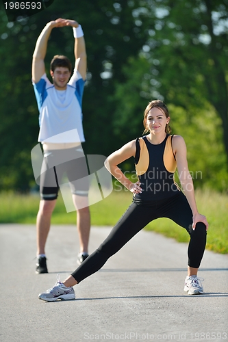 Image of people doing stretching exercise  after jogging