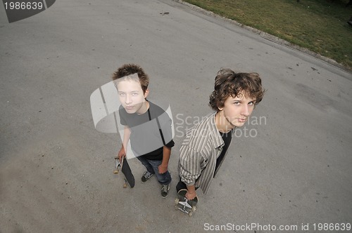 Image of two skate boarders - top view perspective