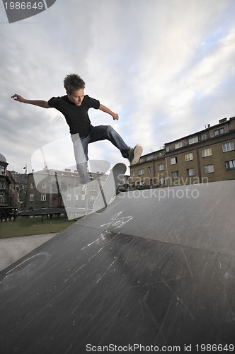 Image of Boy practicing skate in a skate park