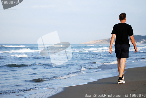 Image of man running on beach