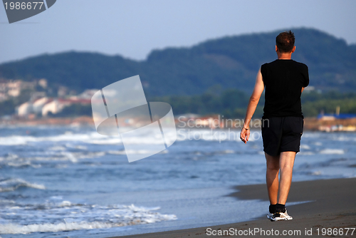 Image of man running on beach