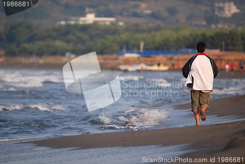 Image of man running on beach