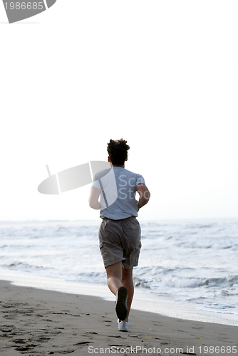Image of man running on beach