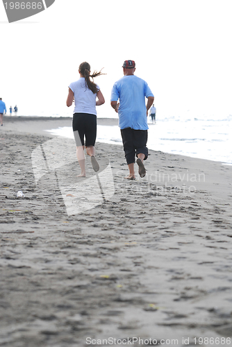 Image of couple running on beach