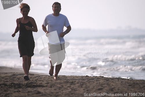 Image of couple running on beach