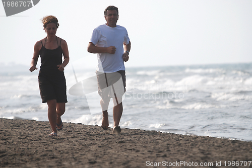 Image of couple running on beach