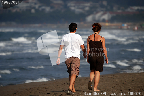 Image of couple running on beach