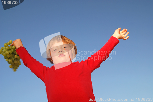 Image of girl with grape outdoor