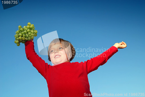 Image of girl with grape outdoor