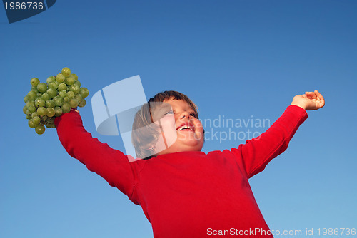 Image of girl with grape outdoor