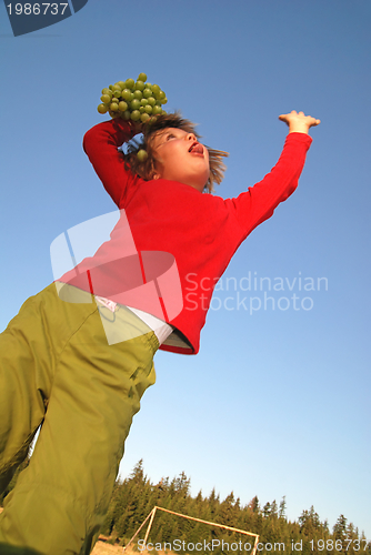 Image of girl with grape outdoor