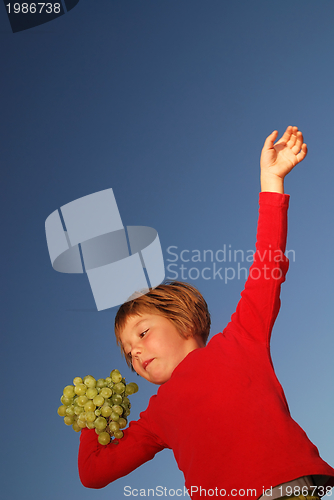 Image of girl with grape outdoor