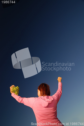 Image of girl with grape outdoor